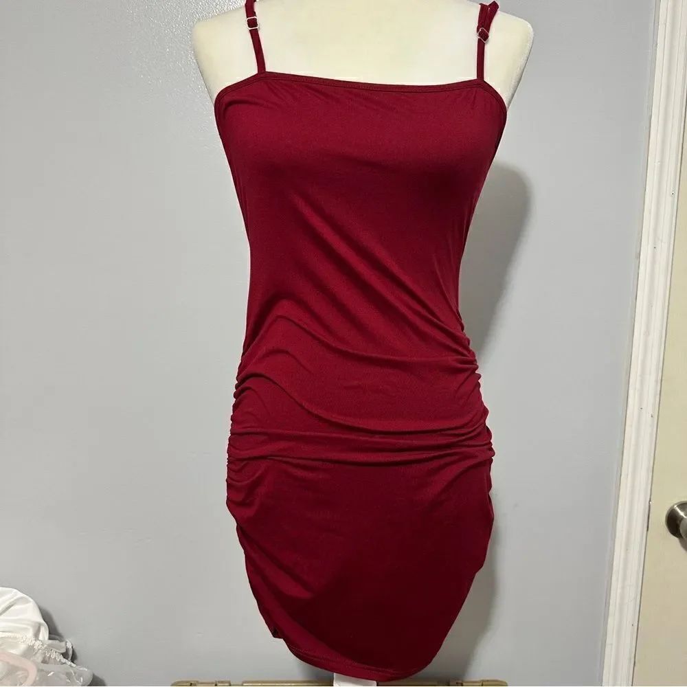 Garnet color fitted dress with tie bow on back, cinch on sides size M